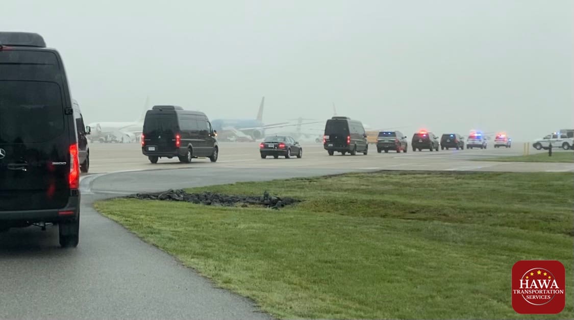 A bunch of cars are driving down the road