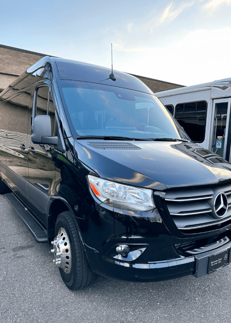 Black Mercedes Sprinter van parked on asphalt.